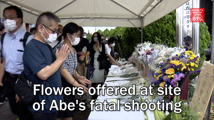 Flowers offered at site of Abe's fatal shooting