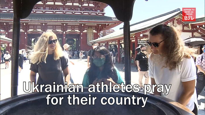 Ukrainian athletes pray for their country at famous temple